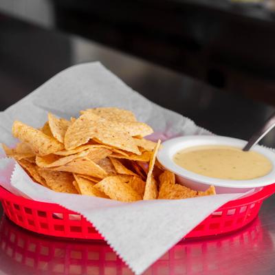 Tortilla chips with cheese dip.