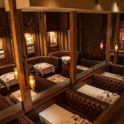 High-angle view of elegant leather booths with white tablecloths.