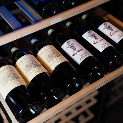 Red wine bottles on a rack.