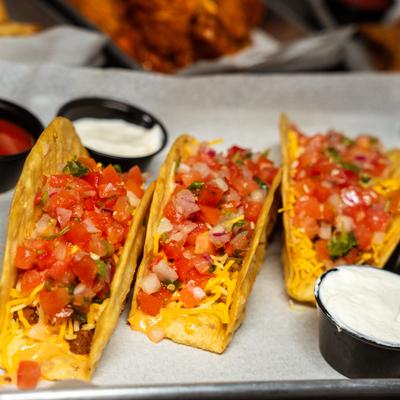 Fried fish tacos served with sour cream and salsa.