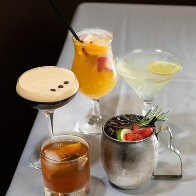 Assorted cocktail drinks on a table.