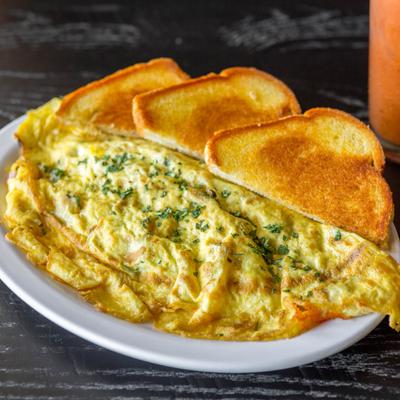 Omelet with ham, cheddar, green peppers, onions, mushrooms, and toast.