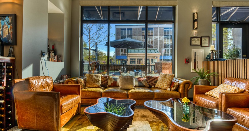 Cozy interior with leather furniture and large window.