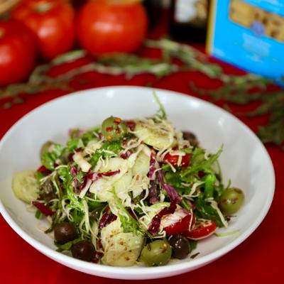 Mixed green salad with olives and tomatoes.