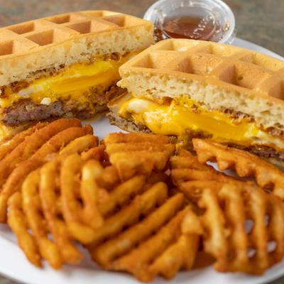 Buffalo chicken waffle sandwich served with waffle fries.