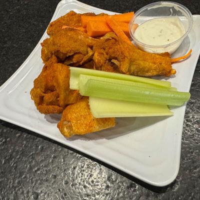 Buffalo wings with celery, carrot sticks, and ranch dipping sauce.