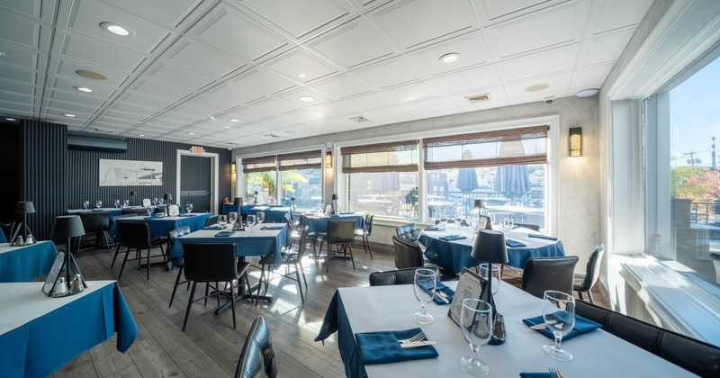 Interior, dining area, tables for four and six people, ready for guests, windows with blinds