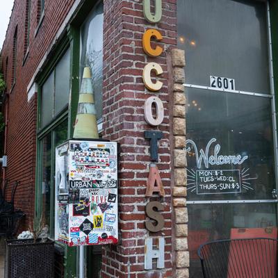 Exterior with a partial view of signage on a brick wall.