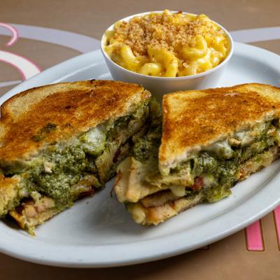 Pesto Sandwich with chicken, grilled onions, cheese and side of mac and cheese.