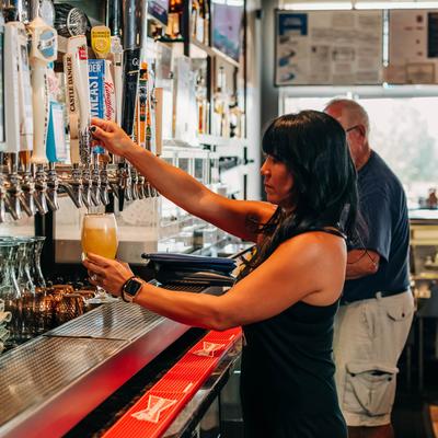 Bartender pouring beer from tap