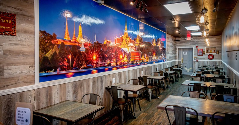 Tables lined up along the wall with a large picture