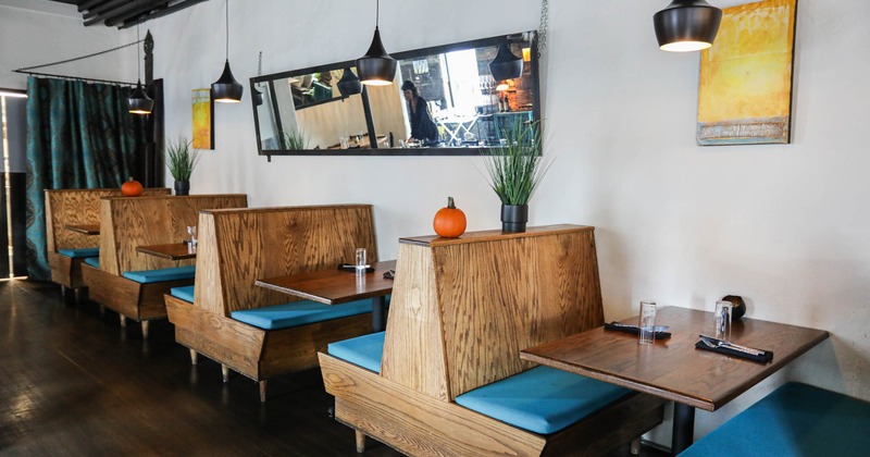 Interior, wooden dining booths with cushions, and table items