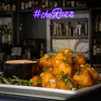 Bang Bang Cauliflower with scallions and creamy sauce.