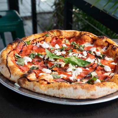 Pepperoni pizza, with goat cheese, basil and balsamic