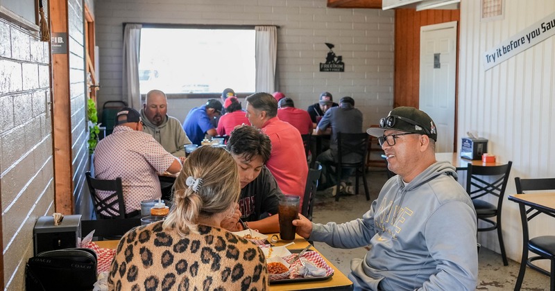 Interior with brick walls and wooden tables and chairs