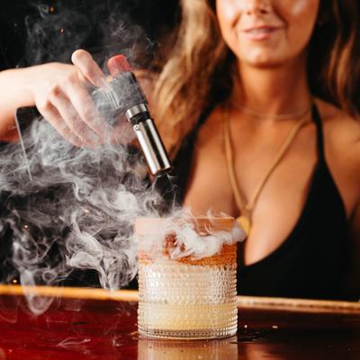 A person making a cocktail.