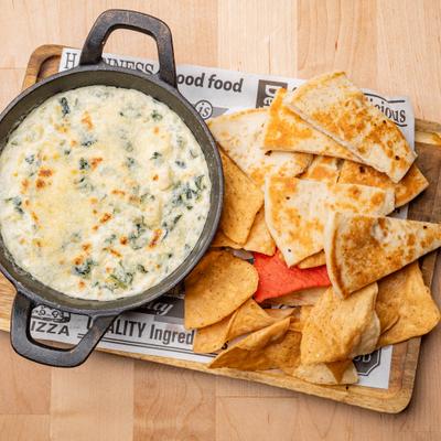 Spinach Artichoke Dip served with pita chops.