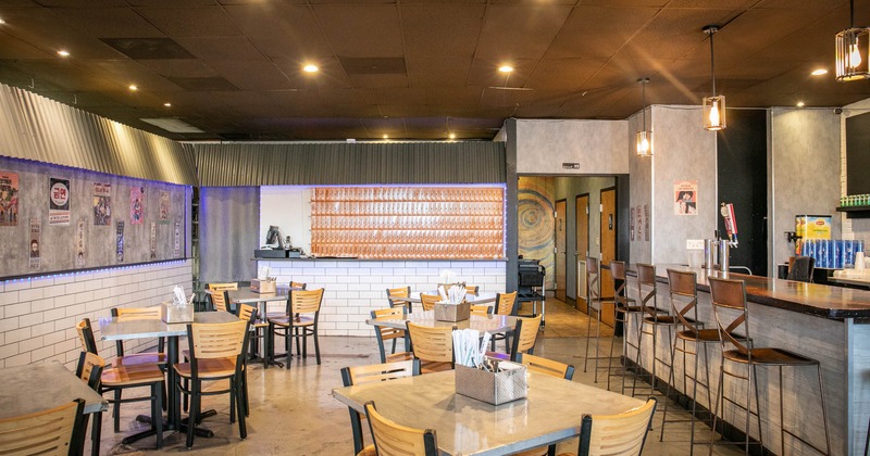 Interior, dining area, bar with stools on the right, back entrance, tile flooring