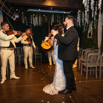 Wedding party with the newlyweds dancing to music performed by a band