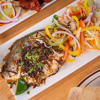 Whole tilapia served with a side salad.