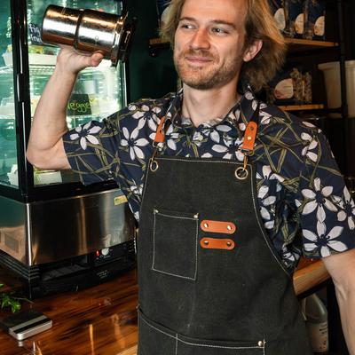 A bartender shaking a cocktail.
