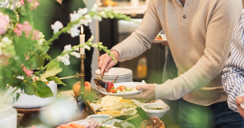 Guests taking food from the buffet table