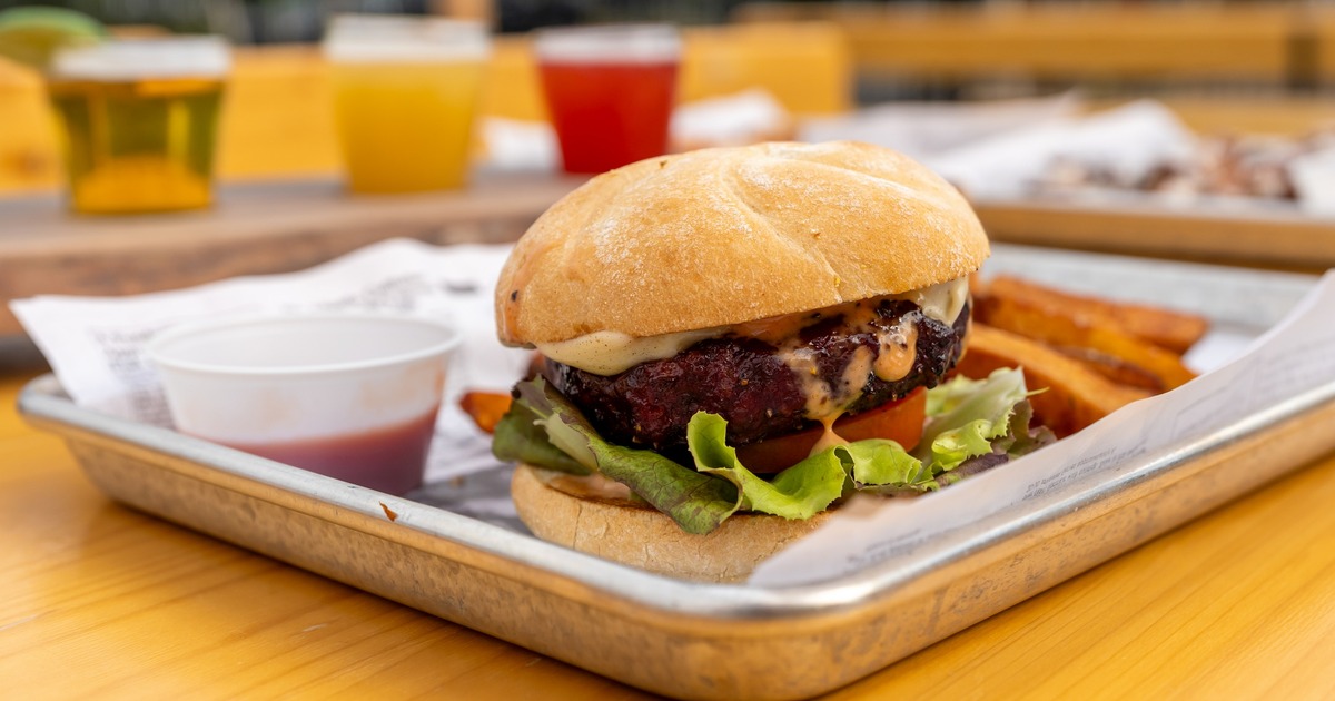 Smoked burger served with fries and dipping sauce