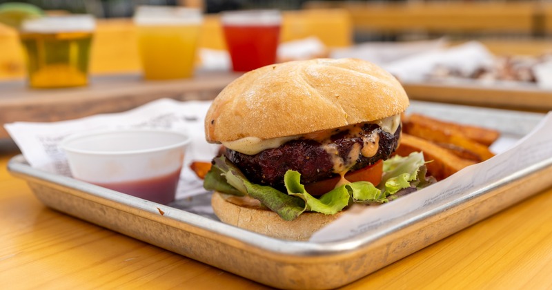 Smoked burger served with fries and dipping sauce