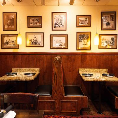 Seating booths, frames on the wall above.