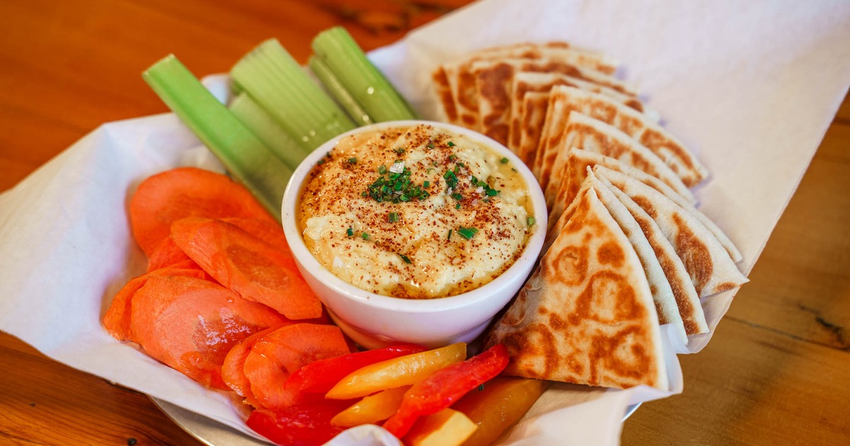 Hummus, served with pita, celery, carrot, and pepper