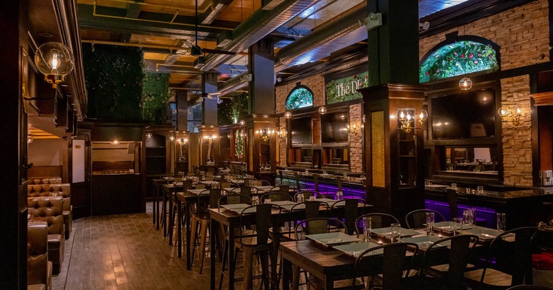 Interior, seating area, bar with bar stools, stone decoration on the wall, lanterns with dim light