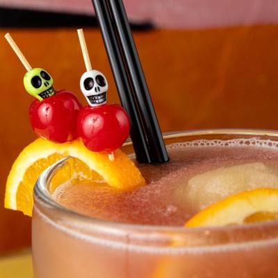 Sangria Margarita garnished with orange slices and cherries.