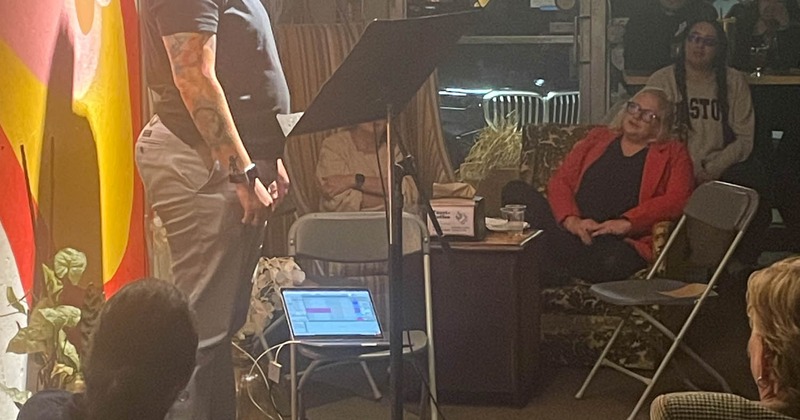 People listening to a person on stage