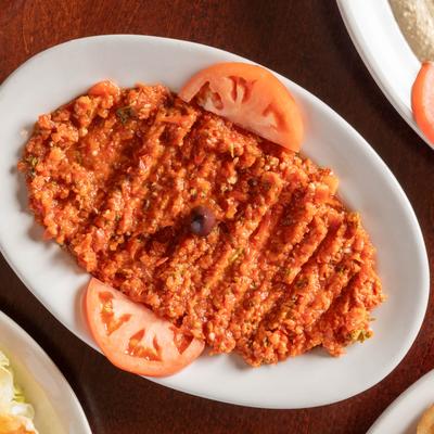 Chopped red and green bell peppers mixed with tomatoes, garlic, parsley, and roasted walnuts.