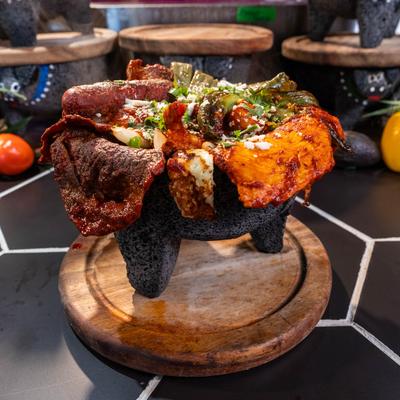 Mixed molcajete with steak, chicken, sausage, shrimp, cactus, and fresh Mexican cheese.