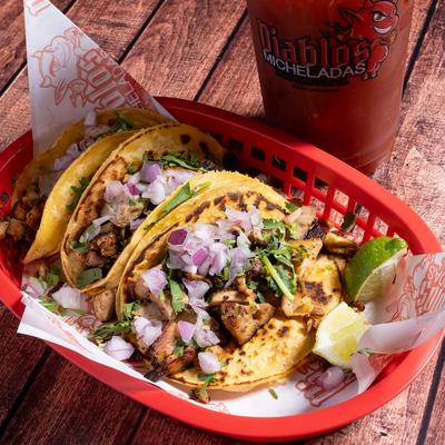 Grilled chicken tacos served with a michelada.