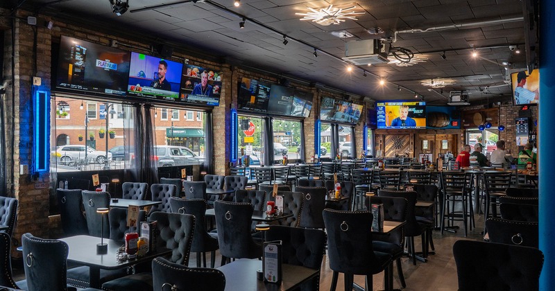 Sports bar interior space, dining area, TV sets on the wall