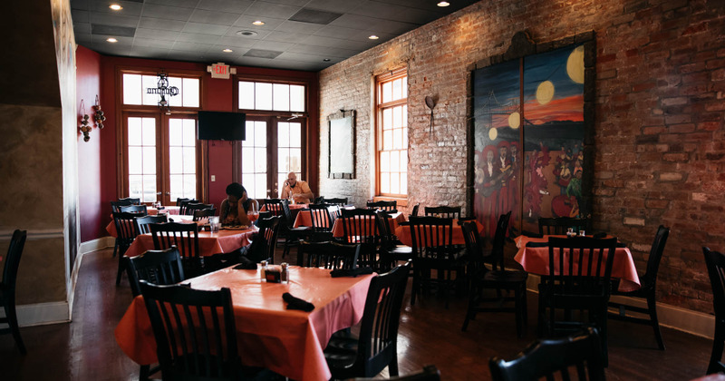 Interior, dining area, two seated guests