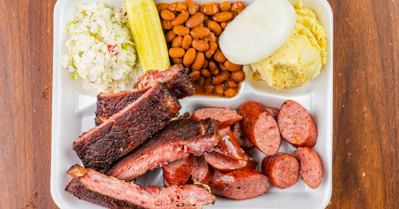 Grilled meat, salad and beans on the side