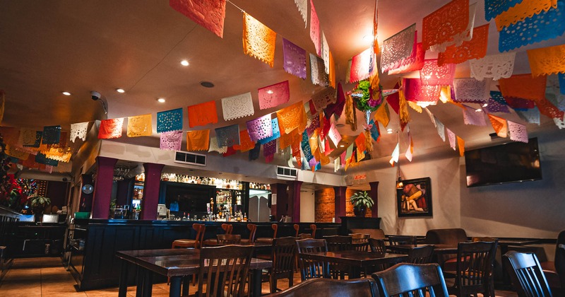 Diner area, tables and chairs, flag color paper decoration above