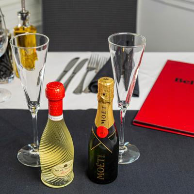 Mini sparkling wine bottles and glasses.