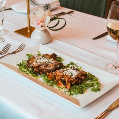 Pan-roasted artichokes with arugula, Parmesan, and a glass of white wine.