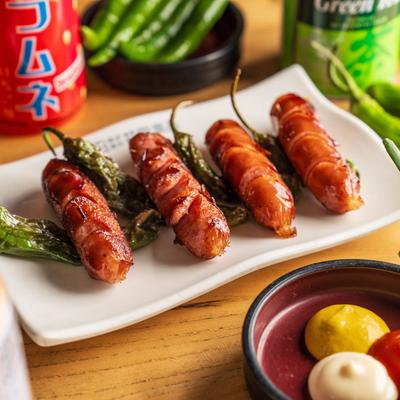 Mini Japanese pork sausages served with dipping sauces and roasted green chilis.