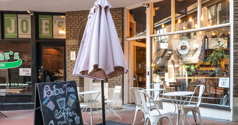 Exterior, tables for two in front of main entrance