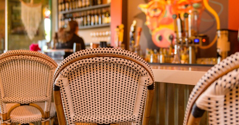 Table and armchairs, bar behind