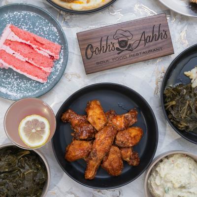A variety of  food dishes, sides, and drinks arranged on a marble tabletop.