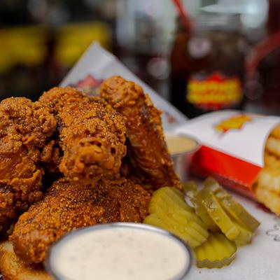 Six piece wings with fries, pickles and sauces.