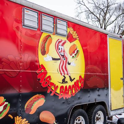 Food truck side with Tasty Bacon's trademark on it.