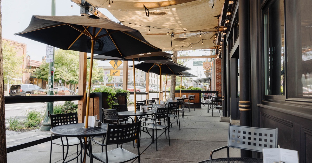 Outdoor seating area, tables and chairs with parasols