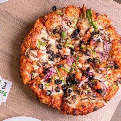 Veggie pizza with mushrooms, black olives, peppers, and onions.